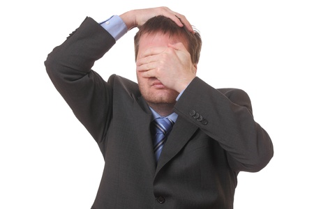 Stressed businessman covering his face with his hands on white backgroundの写真素材