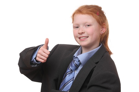 Young girl in an oversized business suit with thumbs upの写真素材