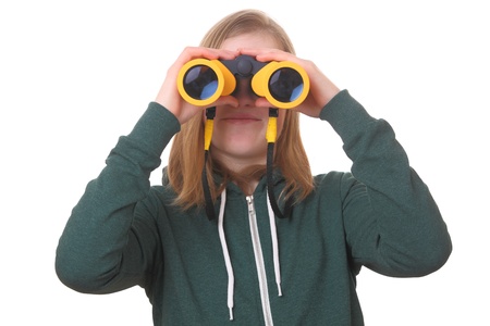 Portrait of a teenage girl with binoculars on white backgroundの写真素材