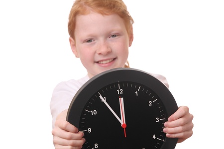 Young girl showing a clock on white backgroundの写真素材