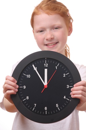 Young girl showing a clock on white backgroundの写真素材