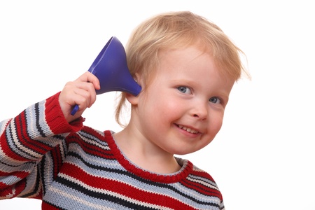 Young kid with an ear-funnel on white backgroundの写真素材