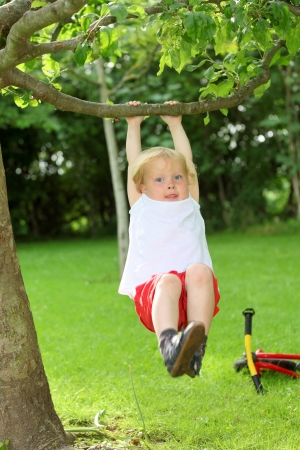 Happy young child playing in the gardenの写真素材