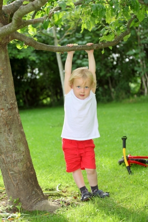 Happy young child playing in the gardenの写真素材