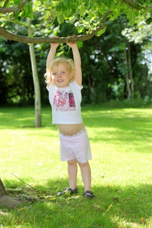 Happy young child playing in the gardenの写真素材