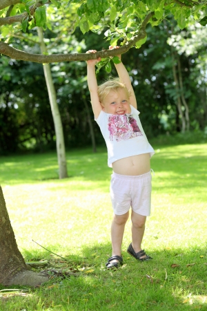 Happy young child playing in the gardenの写真素材