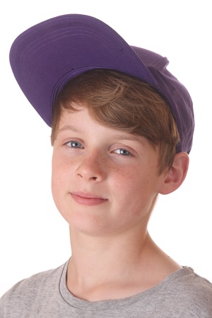 Portrait of a happy teenage boy with cap on white backgroundの写真素材