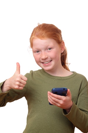Red haired girl with smartphone shows thumbs upの写真素材