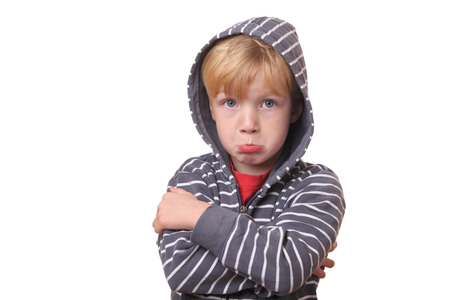 Portrait of a young offended boy on white Backgroundの写真素材