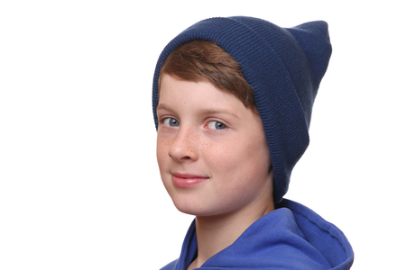Portrait of a young boy wearing a woolen hat on white backgroundの写真素材