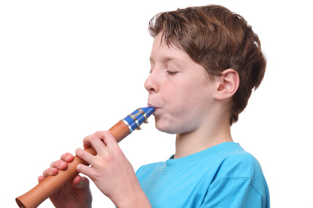 Portrait of a young boy playing the flute on white backgroundの写真素材