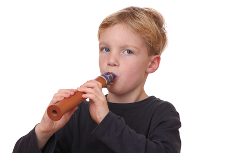 Portrait of a young boy playing the flute on white backgroundの写真素材