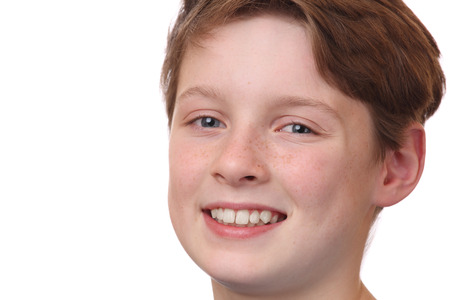 Portrait of a smiling young boy on white backgroundの写真素材