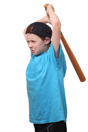Portrait of an angry young boy holding a baseball bat on white backgroundの写真素材