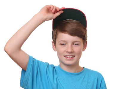 Portrait of a happy boy wearing a baseball cap on white backgroundの写真素材
