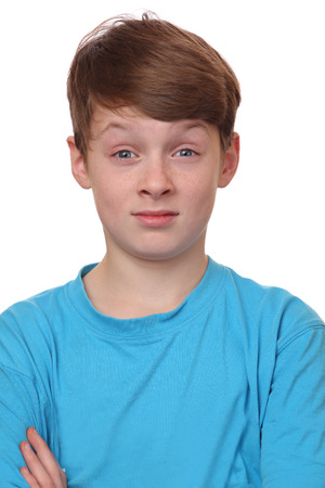 Portrait of a confused young boy on white backgroundの写真素材
