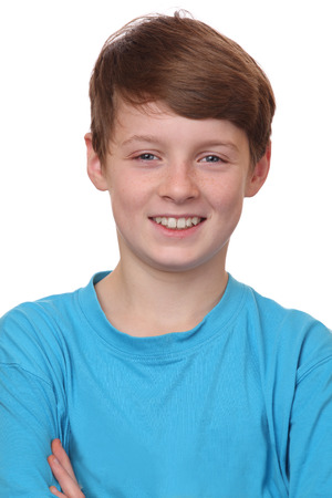 Portrait of a smiling young boy on white backgroundの写真素材