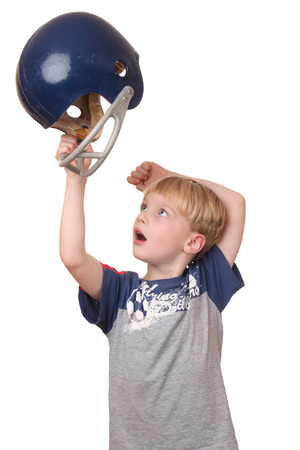 Portrait of a young boy with a football helmet on white backgroundの写真素材
