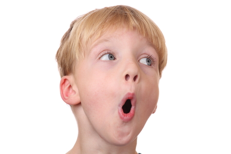 Portrait of a surprised young boy  on white backgroundの写真素材