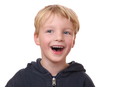 Portrait of a laughing young boy on white backgroundの写真素材