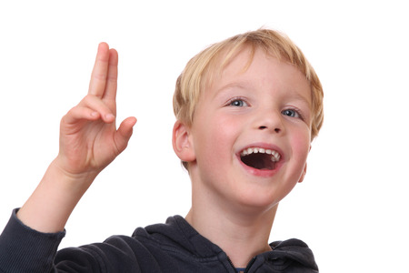 Portrait of a laughing young boy on white backgroundの写真素材