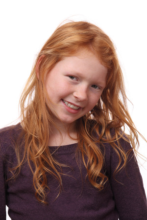 Portrait of a beautiful red-haired girl on white backgroundの写真素材