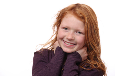 Portrait of a beautiful red-haired girl on white backgroundの写真素材