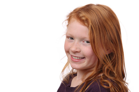 Portrait of a beautiful red-haired girl on white backgroundの写真素材