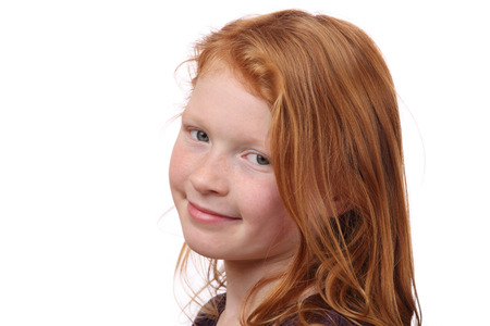 Portrait of a beautiful red-haired girl on white backgroundの写真素材