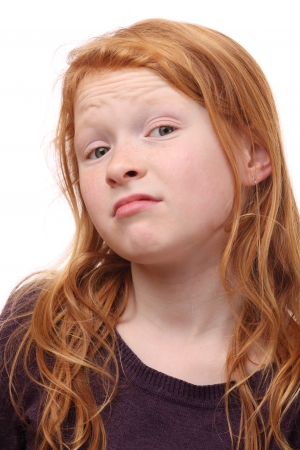 Portrait of a skeptical young girl on white backgroundの写真素材