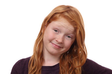 Portrait of a skeptical young girl on white backgroundの写真素材