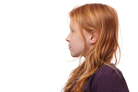 Portrait of a beautiful red-haired girl on white backgroundの写真素材
