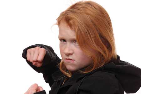 Portrait of an angry young girl on white backgroundの写真素材