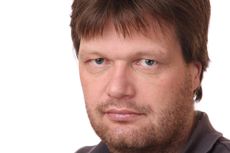 Portrait of a man with serious expression on white backgroundの写真素材