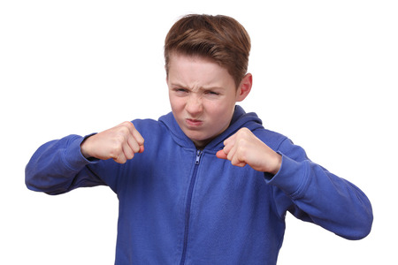 Angry young boy is ready to fightの写真素材