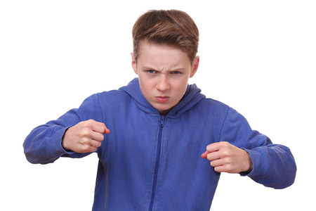 Angry young boy is ready to fightの写真素材