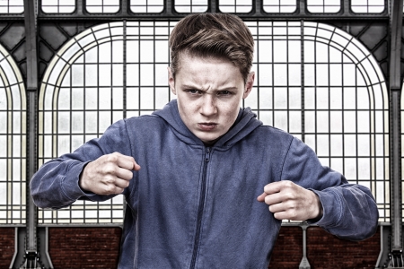 Angry young boy is ready to fightの写真素材