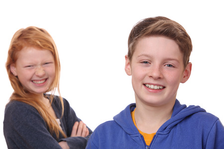 Portrait of happy boy and girl on white backgroundの写真素材