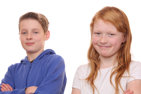 Portrait of happy girl and boy on white backgroundの写真素材