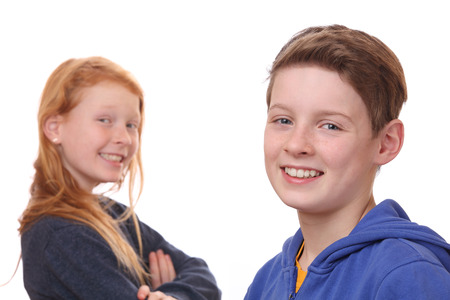 Portrait of happy boy and girl on white backgroundの写真素材