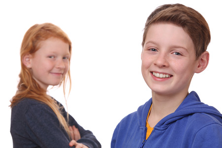 Portrait of happy boy and girl on white backgroundの写真素材