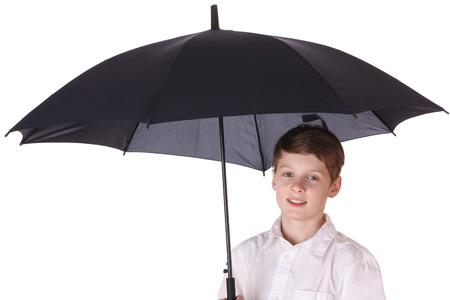 Portrait of a young boy with opened umbrella on white backgroundの写真素材
