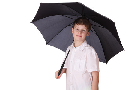 Portrait of a young boy with opened umbrella on white backgroundの写真素材