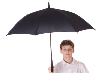 Portrait of a young boy with opened umbrella on white backgroundの写真素材