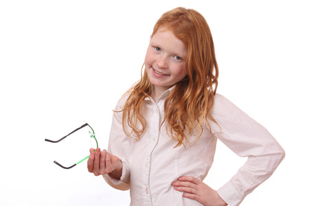 Portrait of a pretty young girl with glasses on white backgroundの写真素材