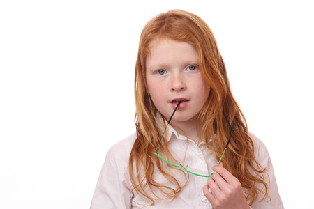 Portrait of a pretty young girl with glasses on white backgroundの写真素材