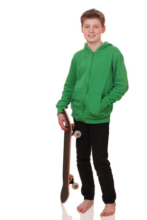 Portrait of a teenage boy with skateboard on white backgroundの写真素材