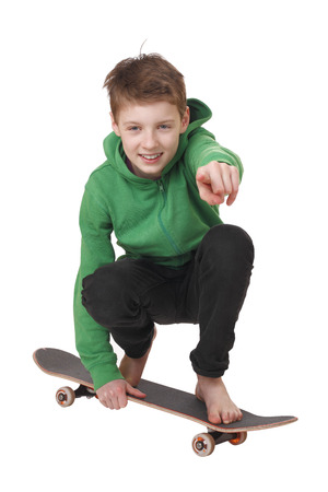 Portrait of a teenage boy with skateboard on white backgroundの写真素材