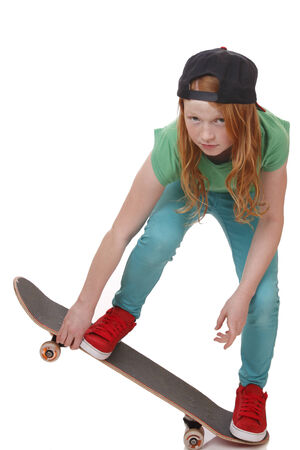 Portrait of a teenage girl with skateboard on white backgroundの写真素材