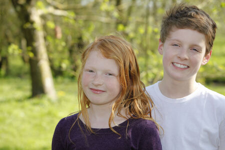Two happy kids outdoor in the gardenの写真素材